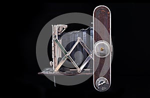 Antique folding camera isolated on the black background