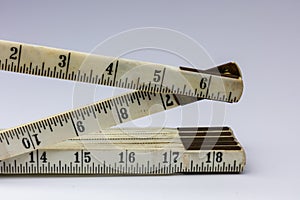 Antique folding ruler on white background