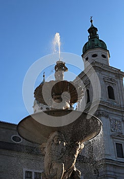 antique fountain with water in the main square of the city of Sa photo