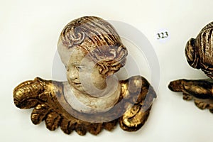 Antique carved baroque cherub angel head on wall with auction number