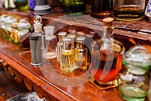 Antique glass jars with spices and perfumes on a vintage retro shelf