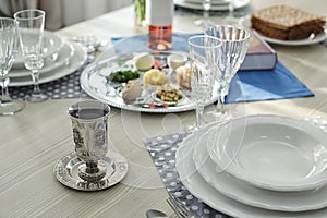 Antique goblet and plates on table served for Passover Pesach