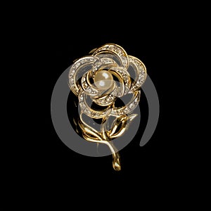 Antique gold brooch with precious stones and crystals in the shape of a flower.