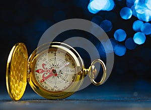 Antique gold clock. Isolated on a dark blue background. Symbol of time, old thing. Beautiful composition. There are no people in