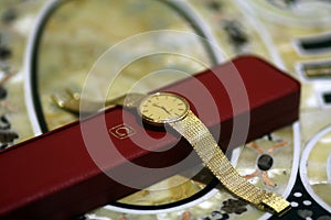 Antique gold men`s watch on a red box