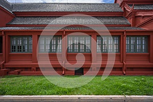Antique green wooden window with red old building and ancient brown roof tiles interior exterior architecture on green natural