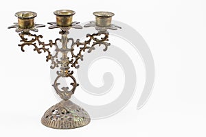 Antique grunge brass candlestick isolated on white background