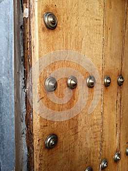 Antique half-open door with bronze nails
