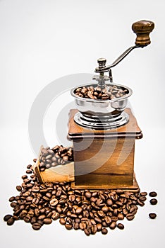 Antique hand crank coffee grinder and roasted coffee beans