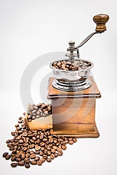 Antique hand crank coffee grinder and roasted coffee beans