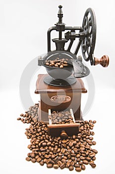 Antique hand crank coffee grinder and roasted coffee beans