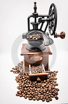 Antique hand crank coffee grinder and roasted coffee beans