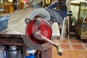 Antique hand-cranked angle grinder on the table