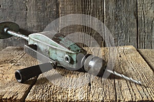 Antique hand drill on the table in the workshop