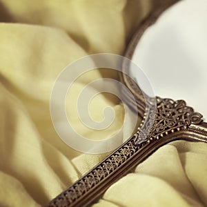 Antique Hand Mirror over Soft Fabric