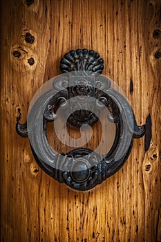 Antique handle of a solid wood door.