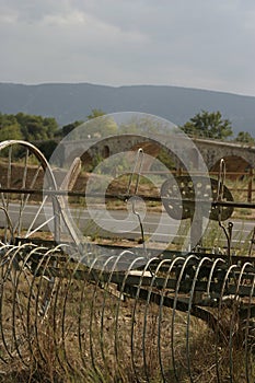 Antique Haymaker by a bridge in the Luberon France