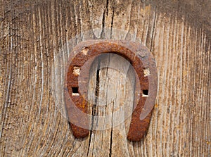 Antique horseshoe luck symbol rusted on vintage wood