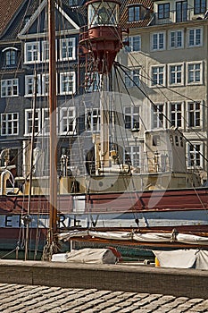 Antique house and old ship moored in Nyhavn, famous Copenhagen l