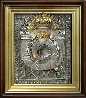 Antique icon of St. Nicholas Wonderworker in a metal framework and in an icon case