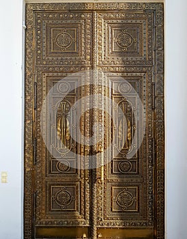 Antique iron door with bas-reliefs