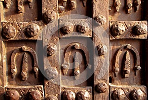 Antique iron door decorated with horseshoes