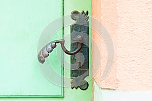 antique iron handle on the background of wooden door