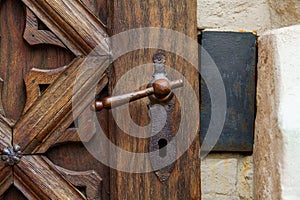 antique iron handle on the background of wooden door