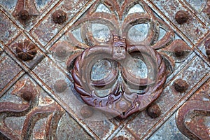 Antique iron handle on an iron door