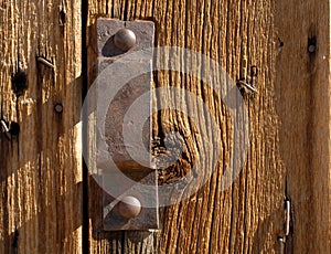 Antique iron handle on weathered door