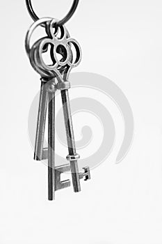 Antique keys with house wooden keyring with white background