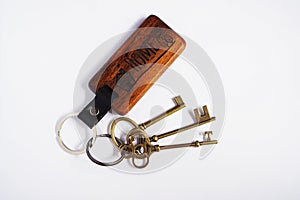 Antique keys with house wooden keyring with white background