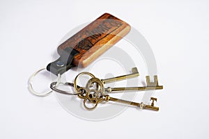 Antique keys with house wooden keyring with white background