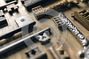 Antique keys on a wooden background