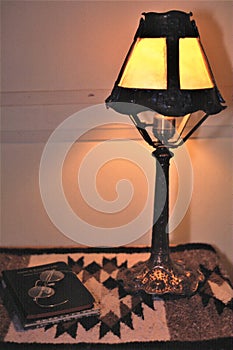 Antique lamp glasses and  two book on table