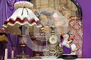 Antique lamp with lampshade, clock and large glass vases