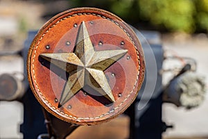 Antique leather ornament decorated with metal Texas star