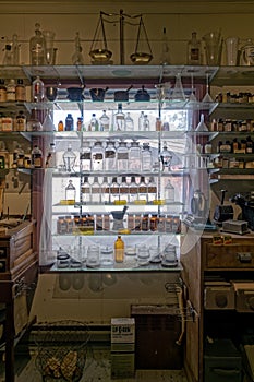 Antique medicine bottles on a shelf in the window in California, USA - November 6, 2022