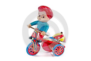 Antique metal bicycle toy with boy toy isolated on white background