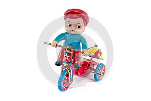 Antique metal bicycle toy with boy toy isolated on white background