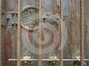 Antique metal ornamental detail on rusty wrought iron wall and grilles. Rusty painted old ornate decorative wrought metal grill in
