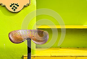 Antique Metal Stool in Front of a Colorful Shop