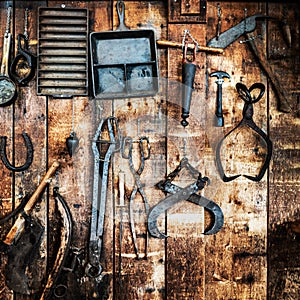 Antique metal tools on a wodden wall