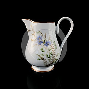 Antique milk jug with floral pattern.