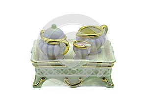 Antique miniature bone china tea set with tiny tea pot milk and sugar bowl on a serving tray also made from bone china or