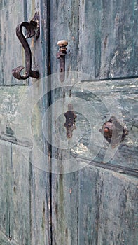 Antique old blue wood door with origin doorknocker