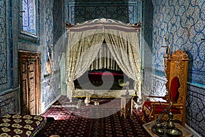 An antique oriental-style bed inside room of the palace. the room of the concubine or wife of the khan of the Khorezm photo