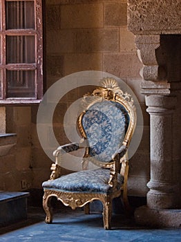 Antique ornate armchair in castle setting