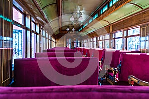 Antique passenger car interior with red louver seats