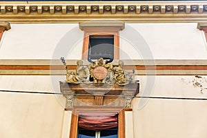 Antique Piety building window decoration in Bologna, Italy